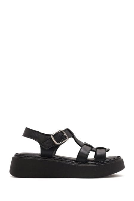 صندل زنانه مشکی چرم سگک‌دار تخت ضخیم راحتی دری مد