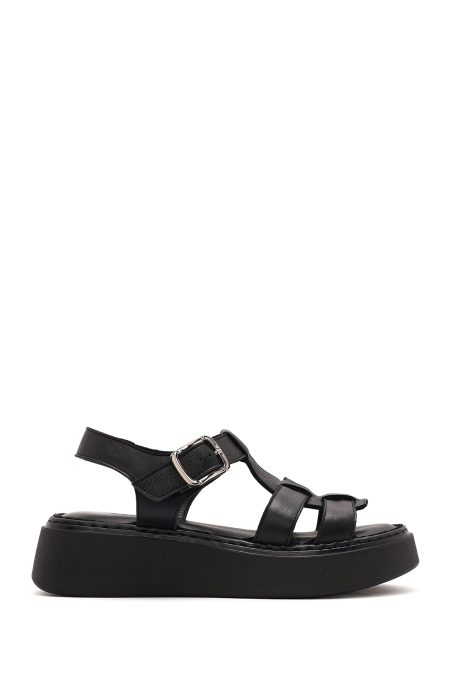 صندل زنانه مشکی چرم سگک‌دار تخت ضخیم راحتی دری مد